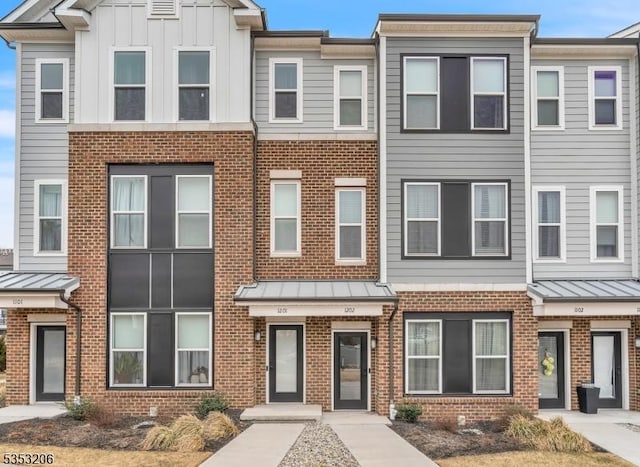 1 Sadie Cir Unit 1202, Union Twp, NJ 07083 - view of property featuring a standing seam roof, metal roof, and brick siding