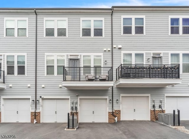 1 Sadie Cir Unit 1202, Union Twp, NJ 07083 - back of property with brick siding, driveway, and an attached garage