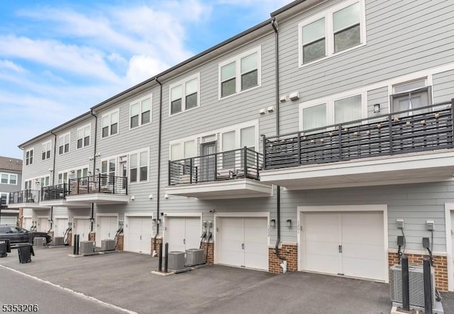 1 Sadie Cir Unit 1202, Union Twp, NJ 07083 - back of house with cooling unit and a garage
