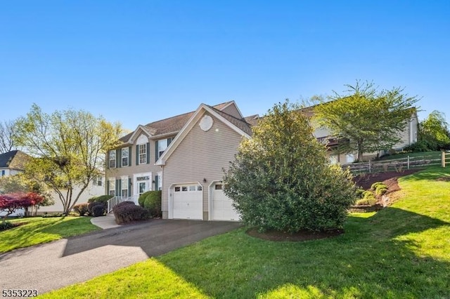 view of front of house with a front lawn, aphalt driveway, and fence