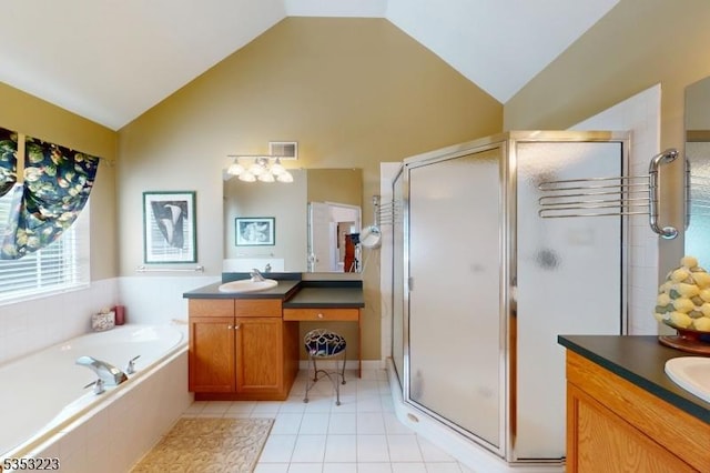 full bathroom with a shower stall, two vanities, a sink, and a garden tub