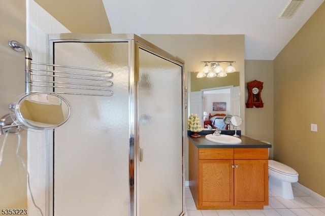 ensuite bathroom featuring visible vents, tile patterned flooring, a shower stall, a sink, and baseboards