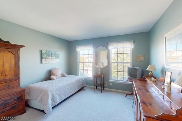 bedroom featuring baseboards and light colored carpet