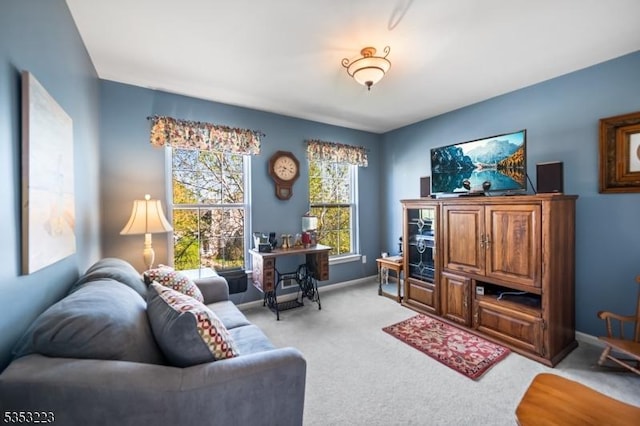living room featuring baseboards and light carpet