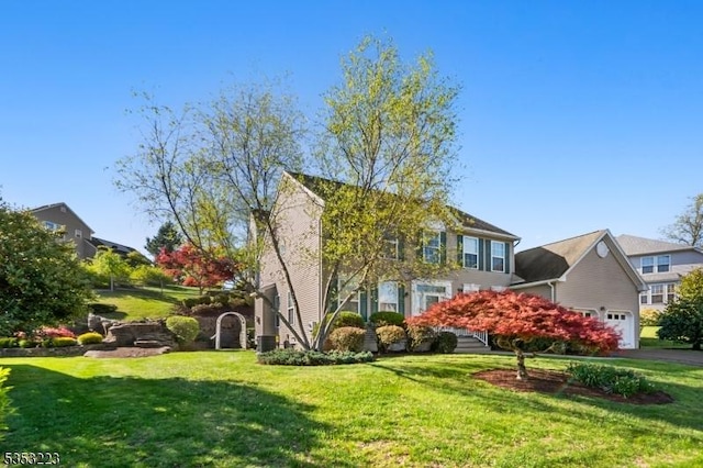 exterior space featuring a lawn, an attached garage, and driveway