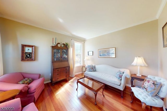 living room with wood-type flooring, baseboards, and crown molding