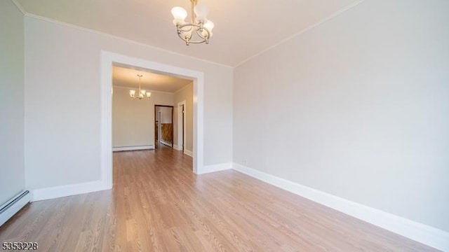 empty room featuring an inviting chandelier, wood finished floors, ornamental molding, and a baseboard heating unit