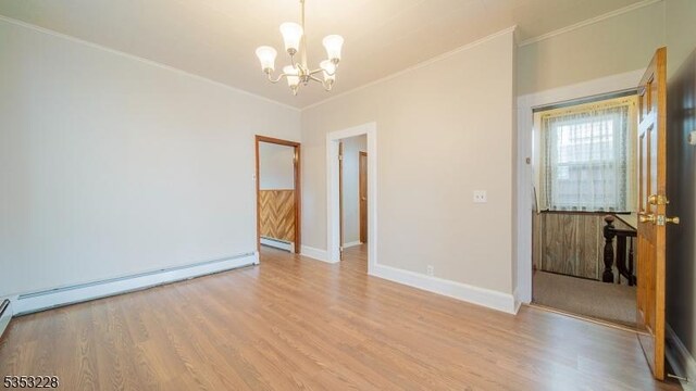 unfurnished room with ornamental molding, a notable chandelier, wood finished floors, and a baseboard radiator