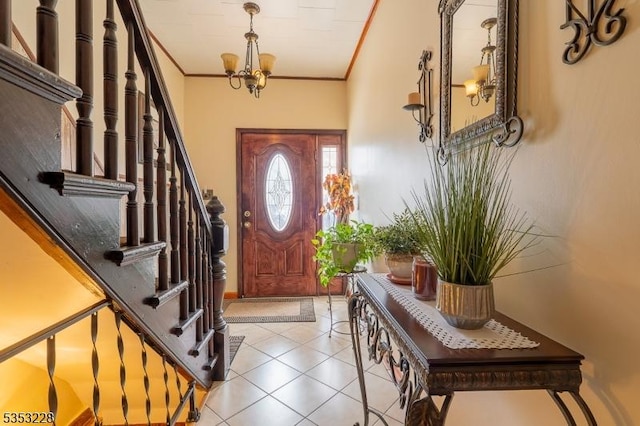 entrance foyer with an inviting chandelier, light tile patterned flooring, stairway, and ornamental molding