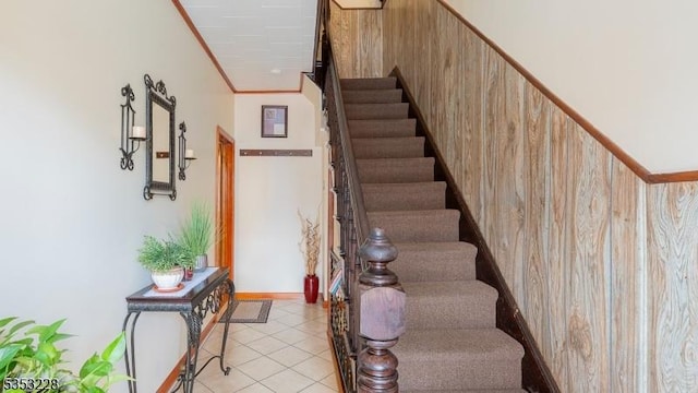 stairs featuring ornamental molding and tile patterned flooring