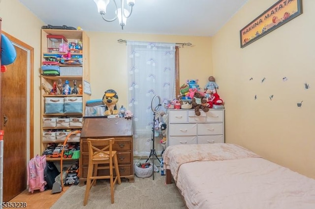 bedroom with a chandelier and carpet