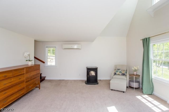 2252 Daniel Bray Hwy, Kingwood Twp, NJ 08559 - sitting room featuring light colored carpet, a wood stove, baseboards, an AC wall unit, and lofted ceiling