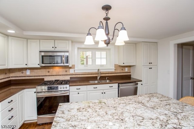 2252 Daniel Bray Hwy, Kingwood Twp, NJ 08559 - kitchen with an inviting chandelier, decorative backsplash, dark stone counters, a sink, and stainless steel appliances