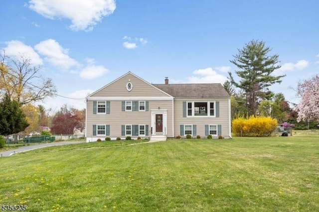 bi-level home featuring a chimney and a front yard