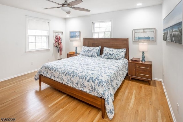 bedroom with wood finished floors, recessed lighting, a ceiling fan, and baseboards