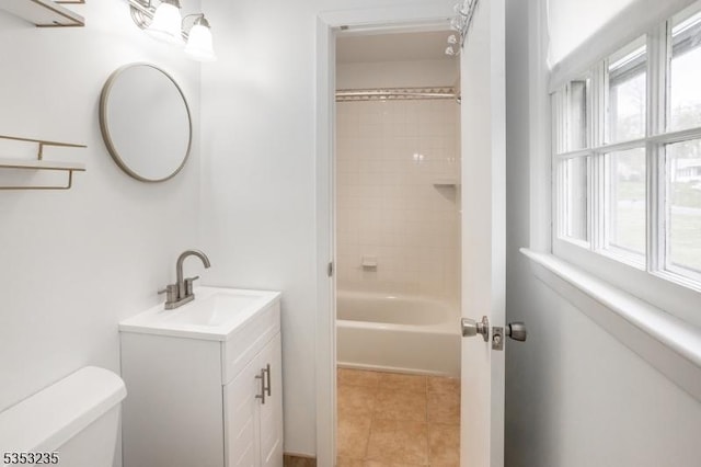 bathroom with toilet, vanity, and tile patterned floors