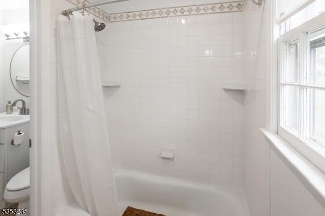 bathroom with shower / bath combo with shower curtain, toilet, and vanity