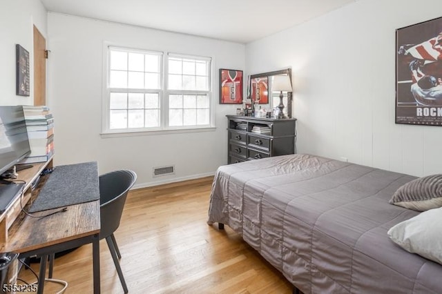 bedroom featuring visible vents, wood finished floors, and baseboards