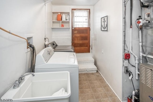 laundry area with washer and clothes dryer, laundry area, and a sink
