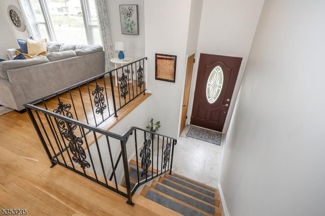 foyer entrance with a wealth of natural light, wood finished floors, and baseboards