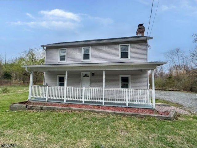 farmhouse-style home with a chimney, a porch, and a front lawn