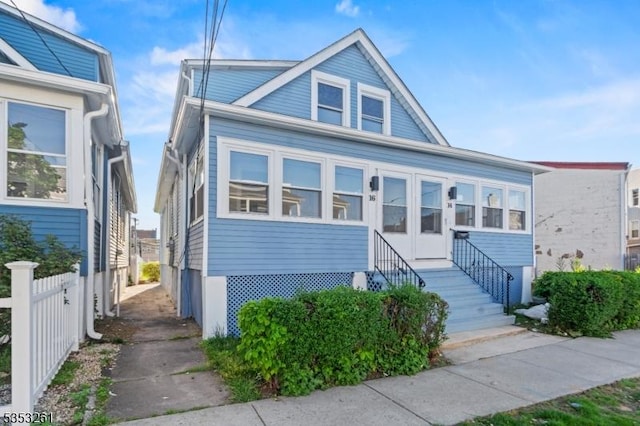 bungalow featuring fence and entry steps