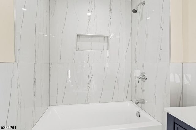 bathroom with bathing tub / shower combination and vanity