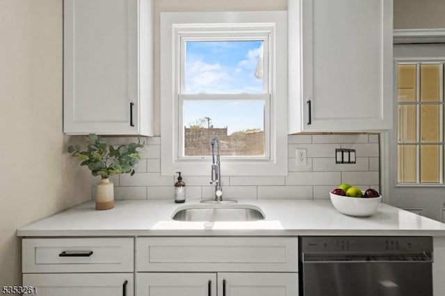 bar featuring a sink, decorative backsplash, and dishwasher
