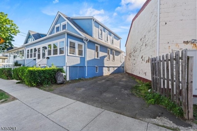view of side of home with fence