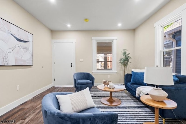 living room featuring recessed lighting, baseboards, and wood finished floors