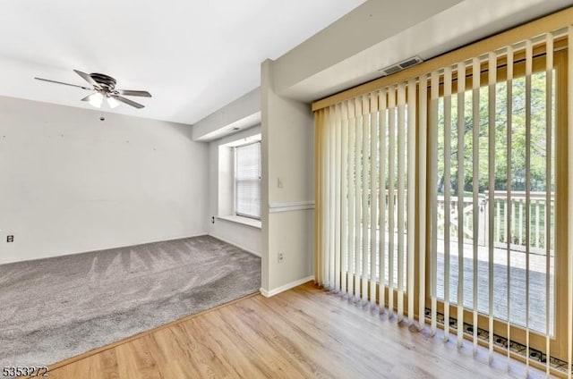 empty room with ceiling fan and wood finished floors