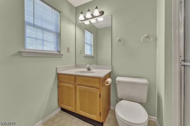 full bath featuring toilet, baseboards, tile patterned flooring, and vanity