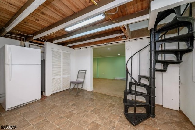 finished basement with freestanding refrigerator, wooden ceiling, a baseboard radiator, stone finish floors, and stairway