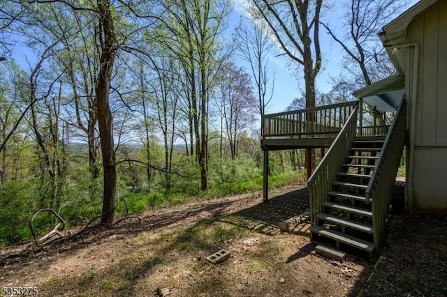 view of yard featuring stairs and a wooden deck