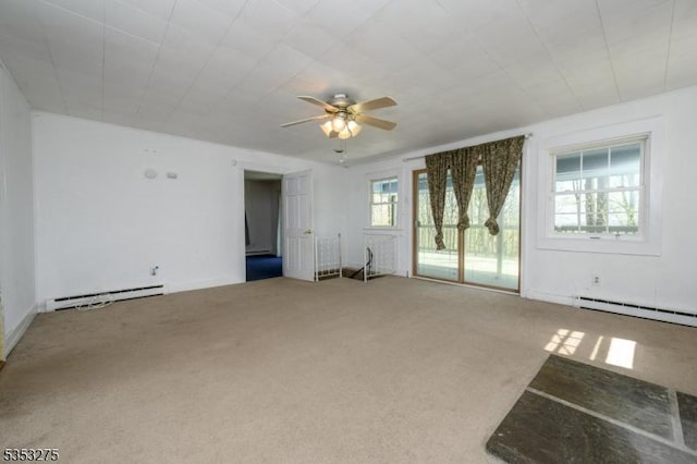 unfurnished living room featuring a baseboard radiator, carpet floors, and a ceiling fan