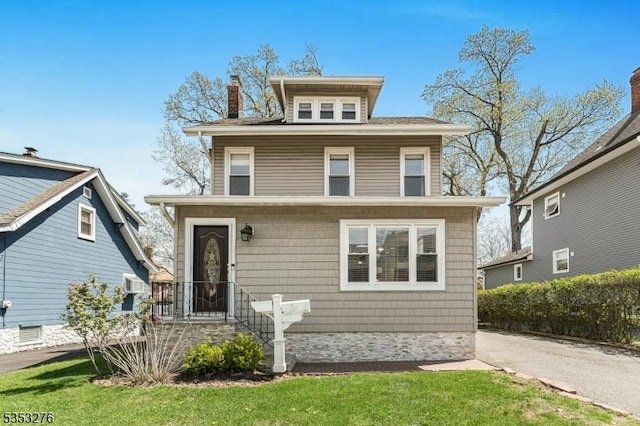 american foursquare style home with a chimney