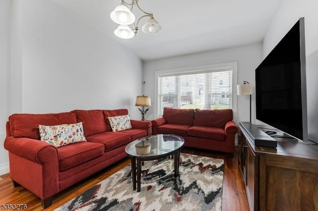 living area with wood finished floors and a chandelier