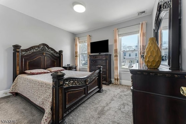 bedroom featuring light colored carpet, baseboards, and visible vents