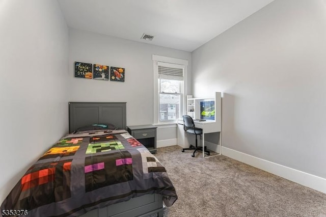 carpeted bedroom featuring baseboards and visible vents