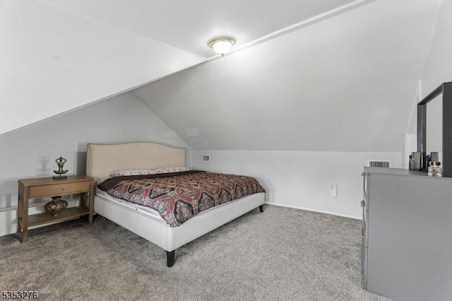 carpeted bedroom with lofted ceiling