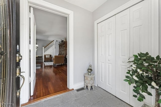 foyer entrance featuring tile patterned floors and baseboards