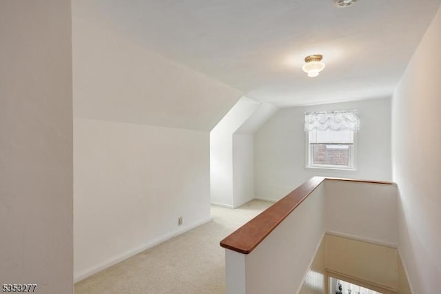 bonus room with baseboards, vaulted ceiling, and carpet