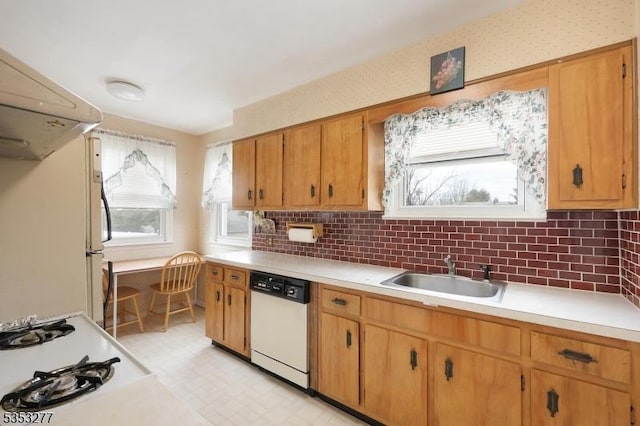 kitchen with white appliances, light floors, light countertops, a sink, and backsplash