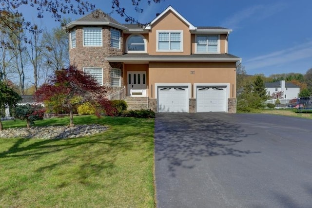 traditional home featuring driveway, stone siding, and stucco siding