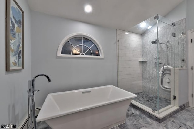 full bath featuring a freestanding bath, a shower stall, and marble finish floor