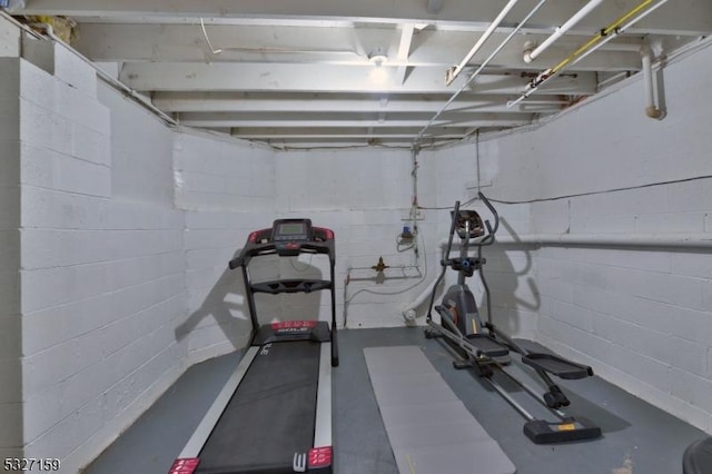 workout area with concrete block wall