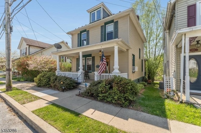 traditional style home with central air condition unit and covered porch
