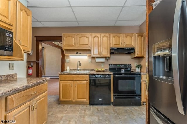 kitchen featuring baseboard heating, a sink, a drop ceiling, under cabinet range hood, and black appliances