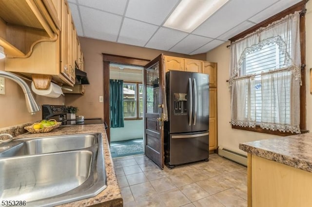 kitchen with baseboard heating, light tile patterned floors, a sink, refrigerator with ice dispenser, and a drop ceiling