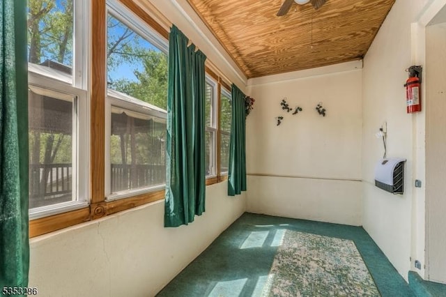 interior space featuring wood ceiling and carpet flooring